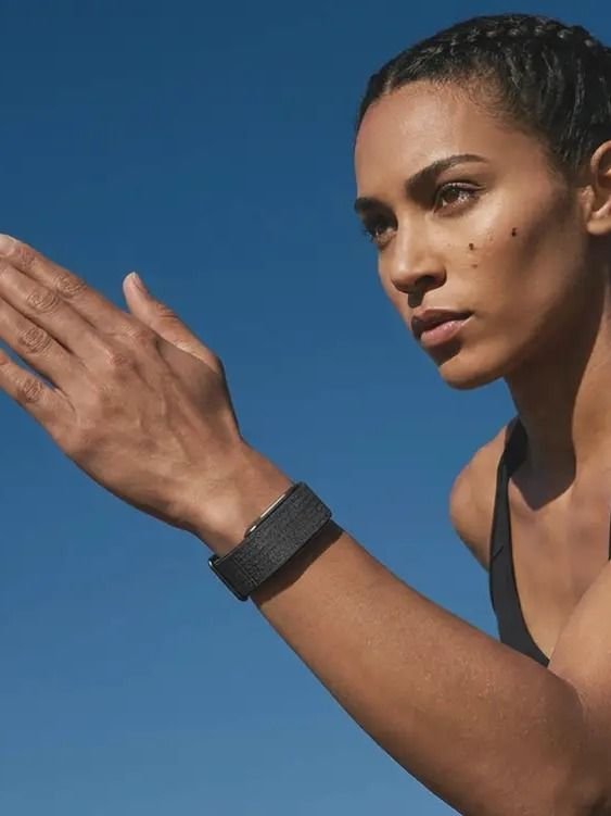 Athletic woman wearing the Hulme Band outdoors — building metabolic momentum