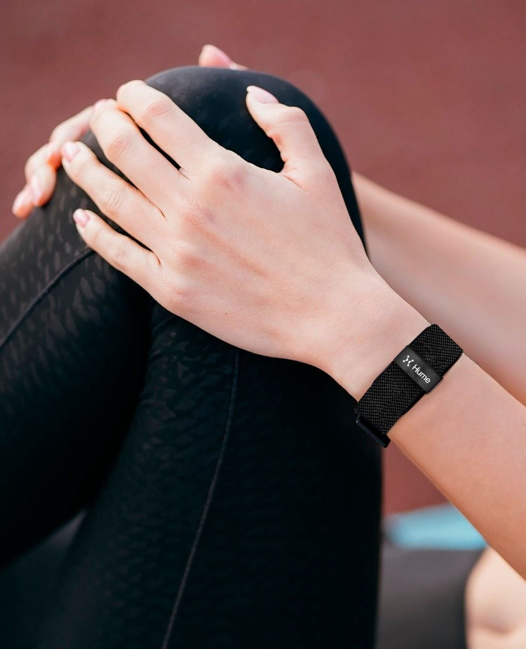 Hands with the Hulme Band on the wrist during a stretching routine